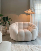 Fauteuil lounge en tissu bouclé
